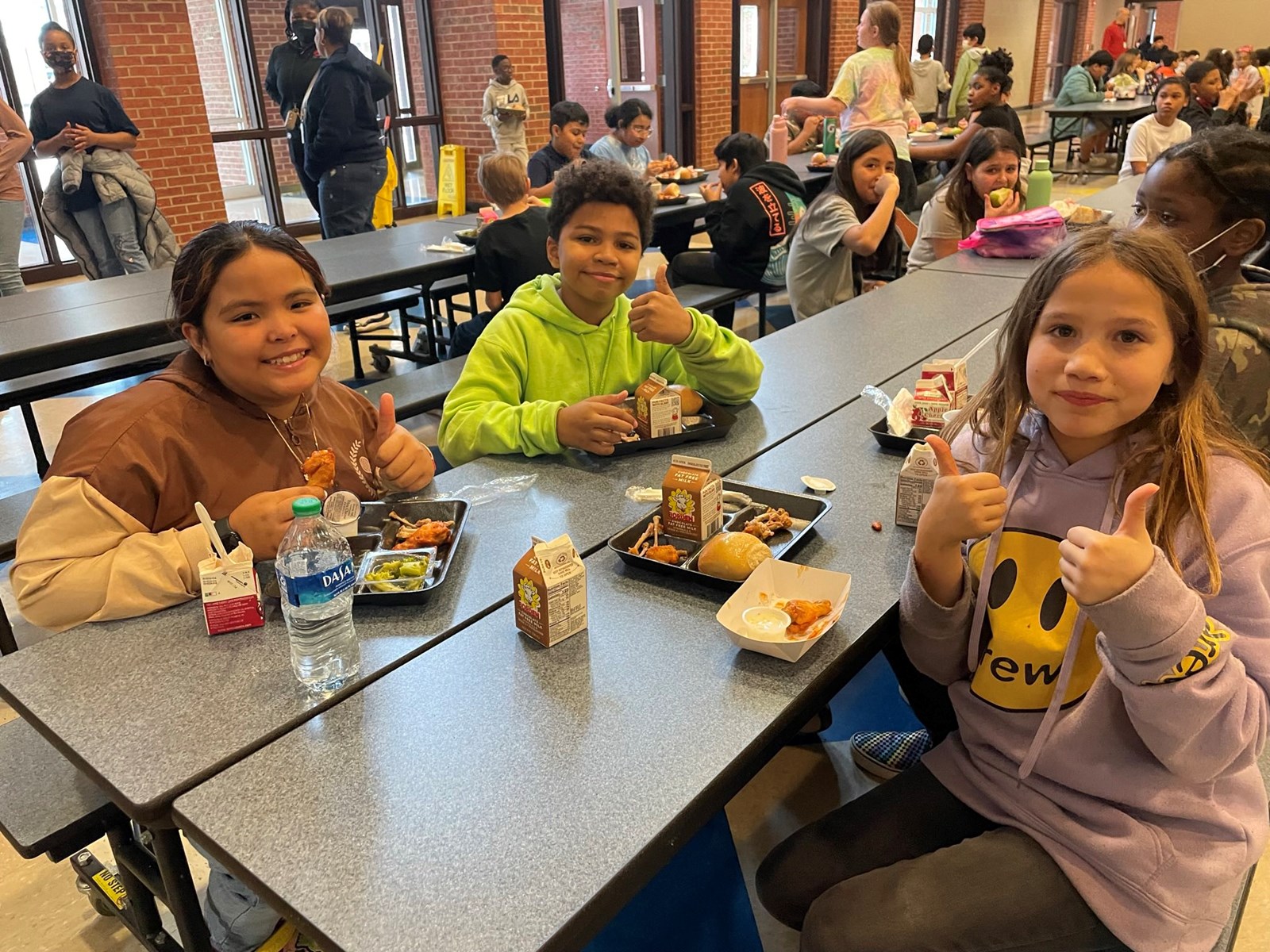 Picture of a happy student enjoying a FNS meal